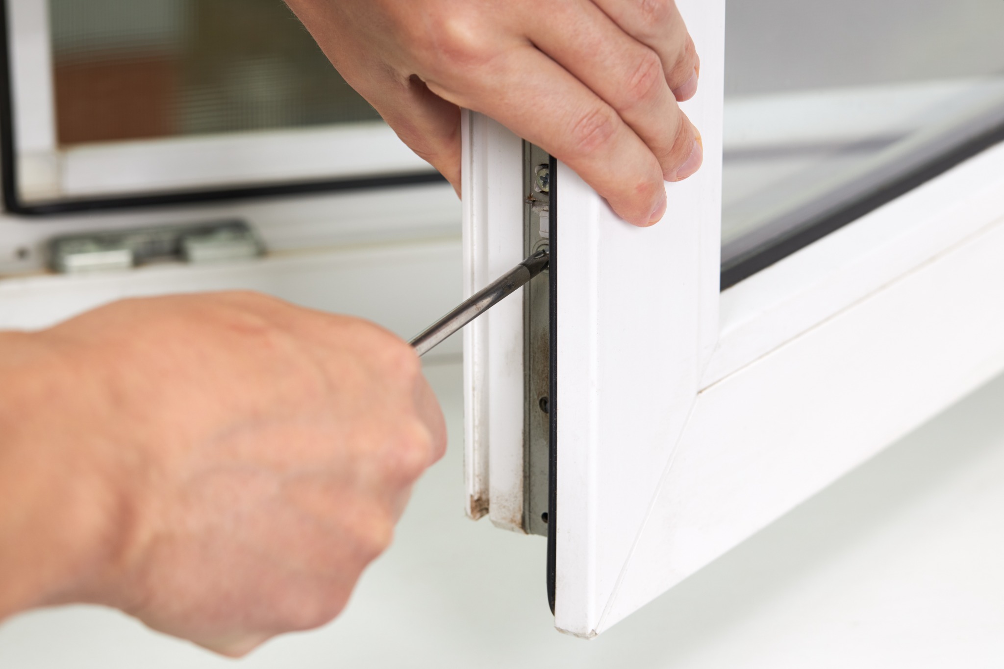 Window hardware being adjusted